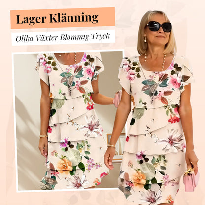 Kaskadklänning med blommönster och flera växter